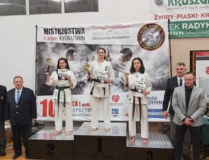 ludzie na podium pokazujący swoje dyplomy i puchary
